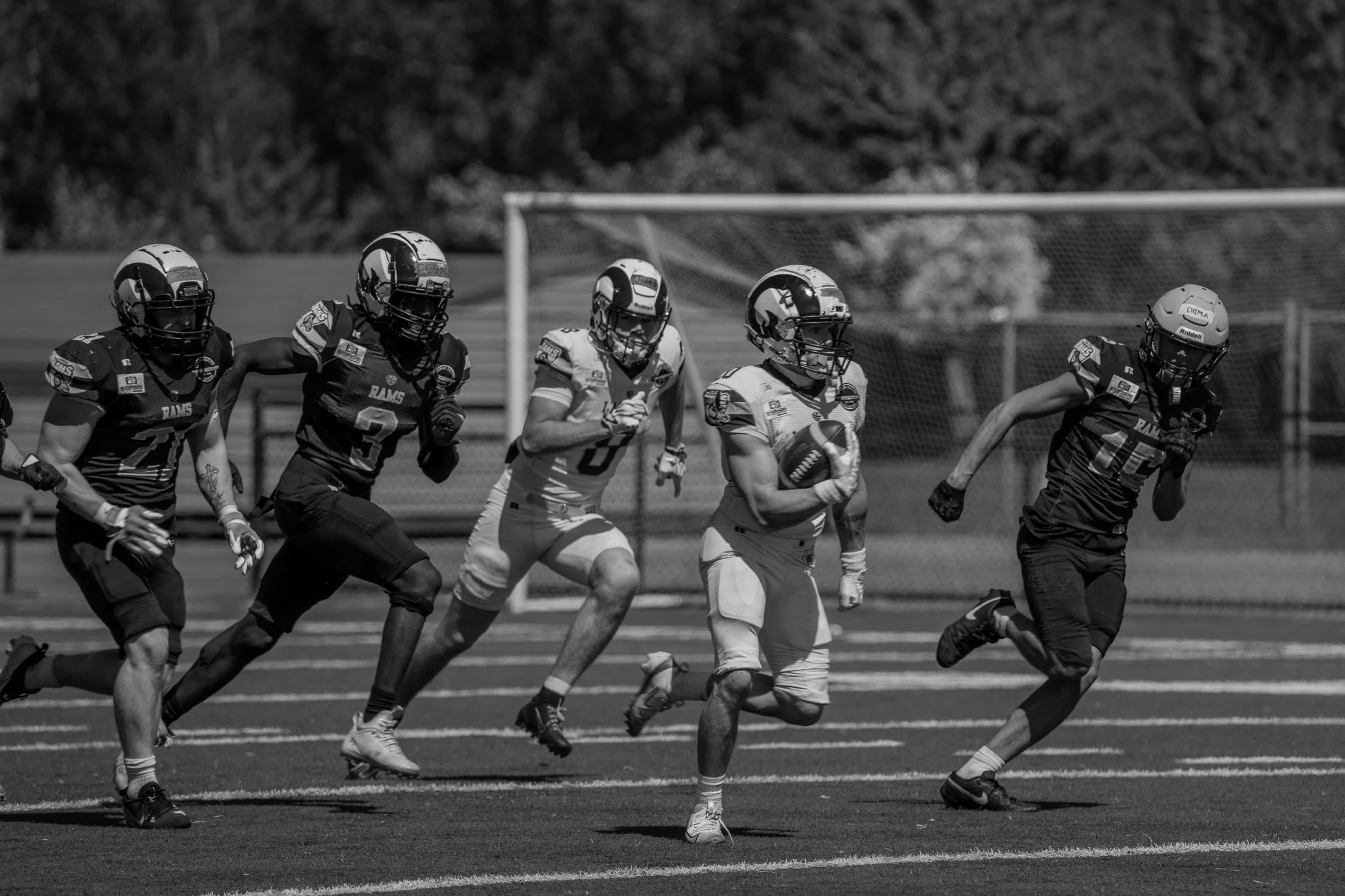 Caiden breaking away with the ball during a football game